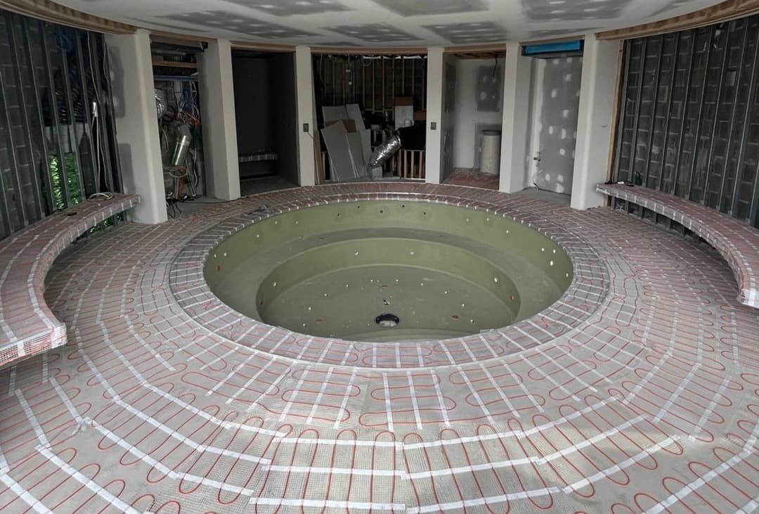 Electric underfloor heating mat prepared below a finished floor