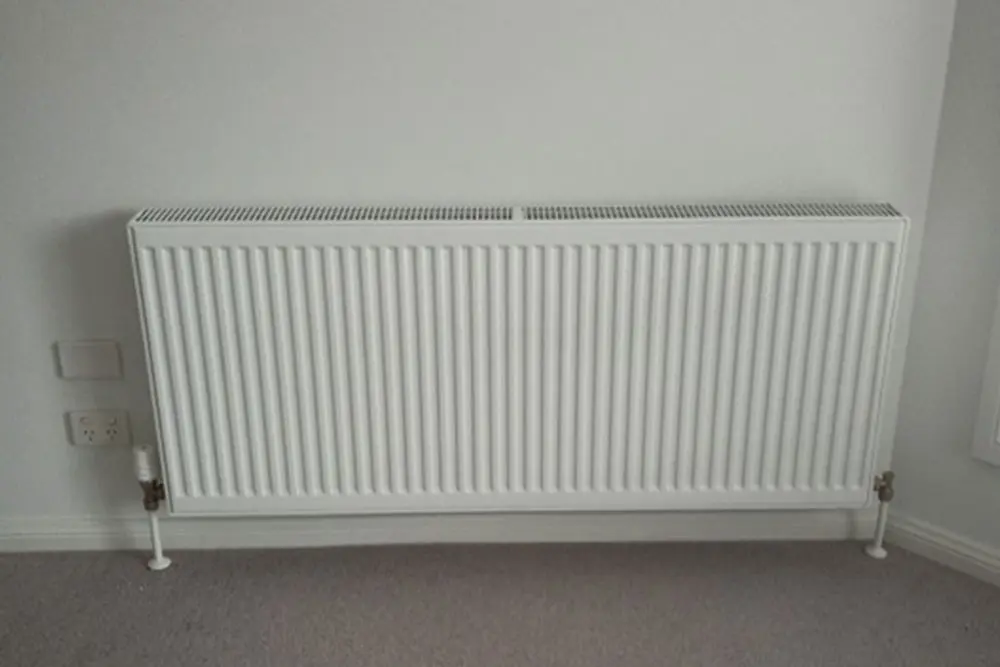 Wall-mounted hydronic radiator installed for room heating