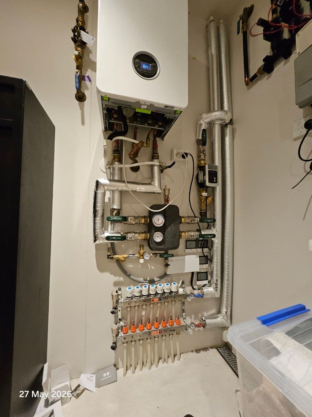 Internal gas boiler plantroom with hydronic manifold, pumps and insulated pipework in a Bar Beach residence.