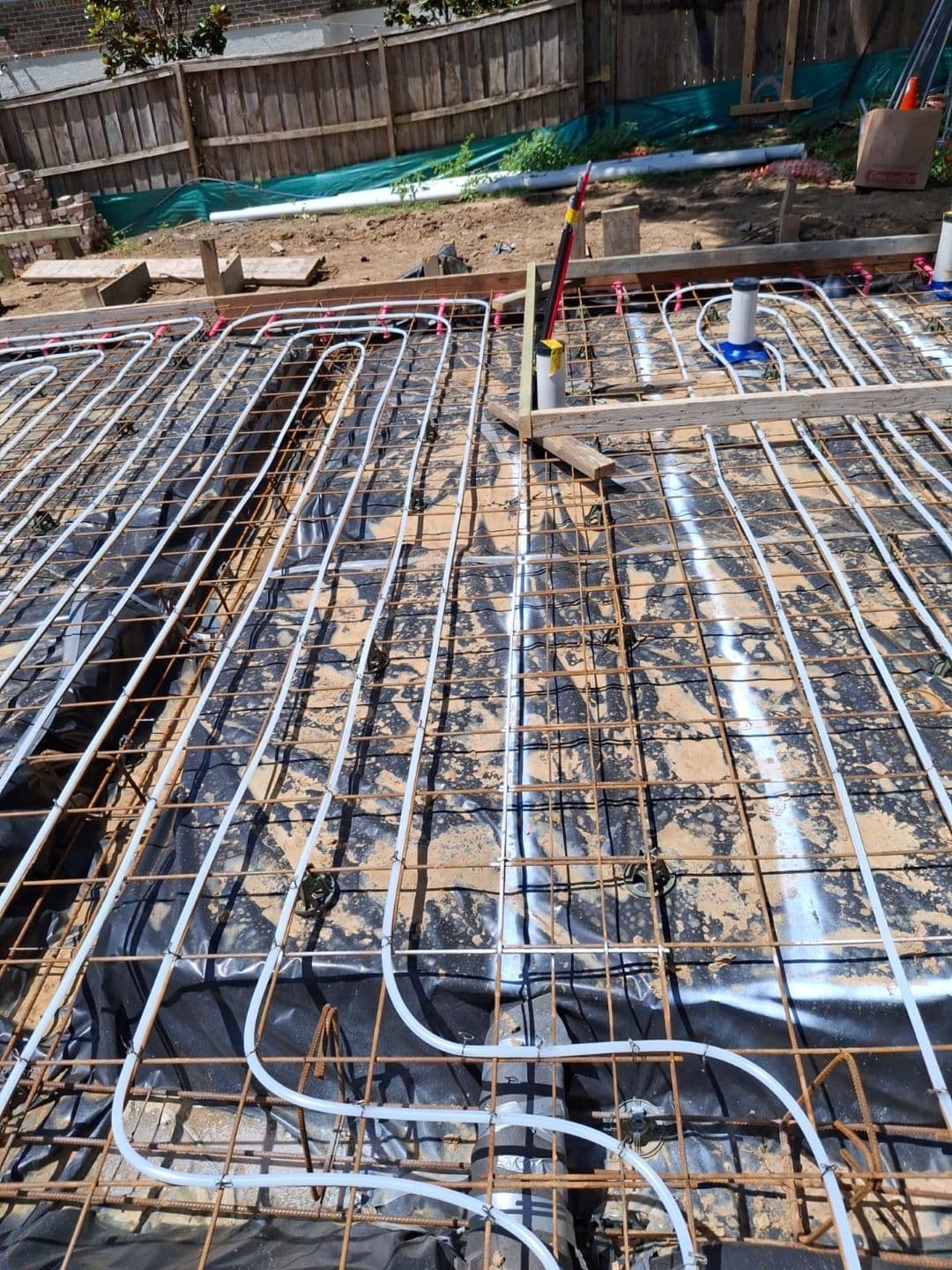 Hydronic heating circuits arranged across a residential slab area.