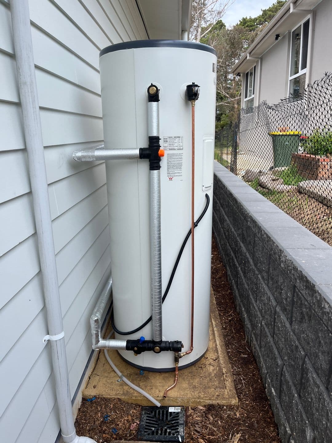 Hot water storage tank connected to a Sanden heat pump with insulated pipework in Katoomba.