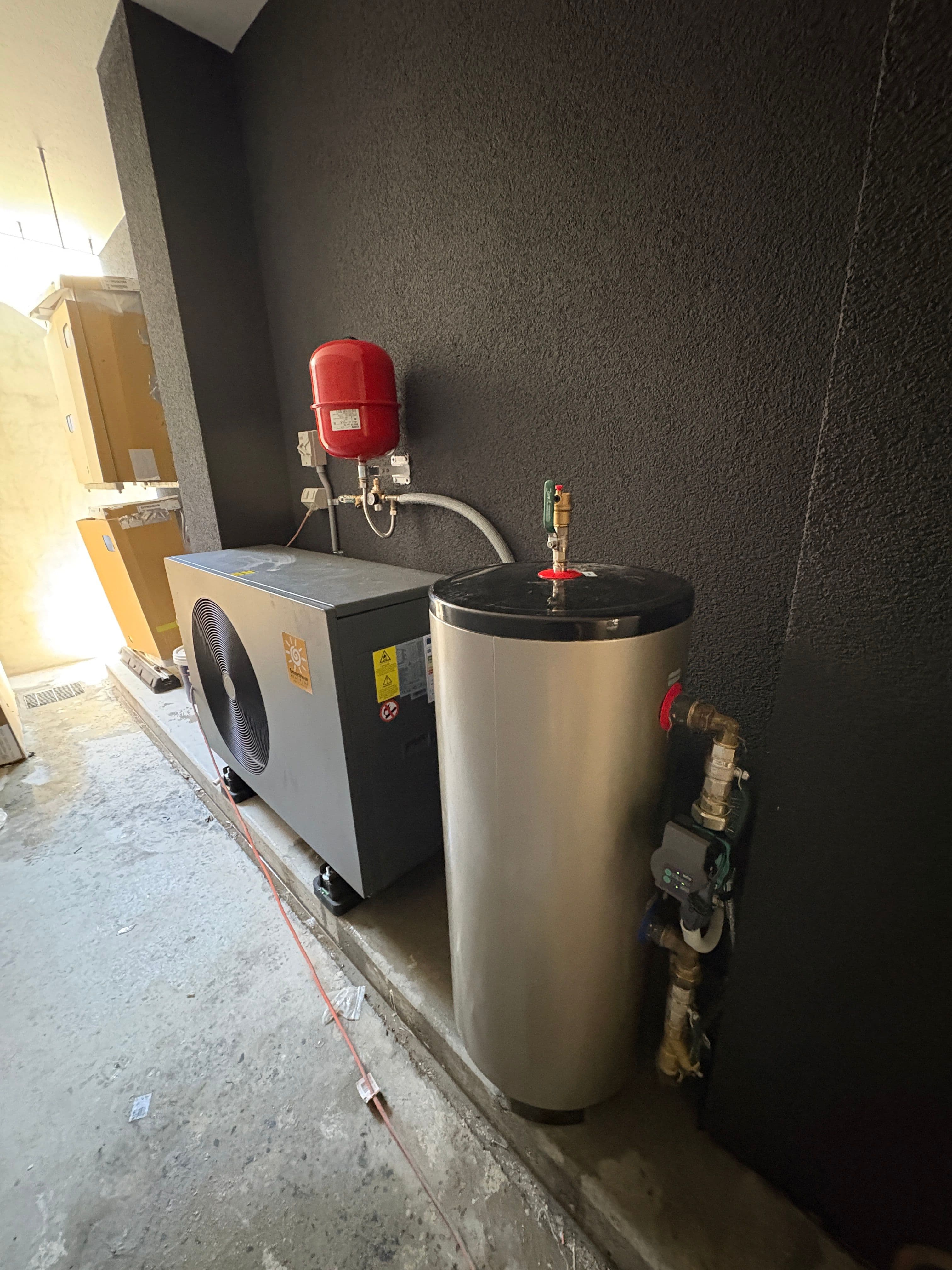 Residential hydronic heat pump connected to a buffer tank, expansion vessel and circulation pump in Kiama Heights.