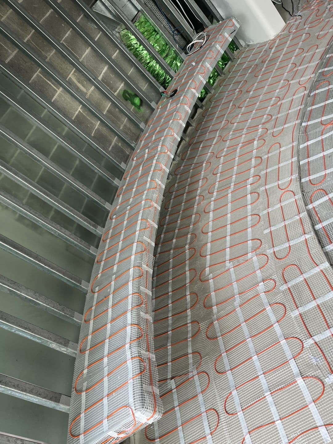 Electric floor heating mats arranged around a circular spa in a custom Bellevue Hill interior.