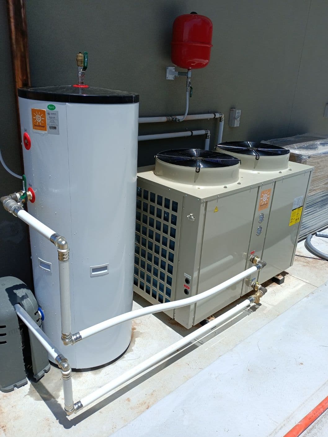 External top discharge heat pump installation supporting a hydronic heating system in Castlereagh.