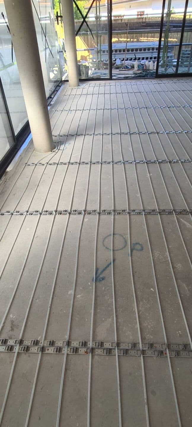 Hydronic heating pipe circuits coordinated around service penetrations and room transitions.