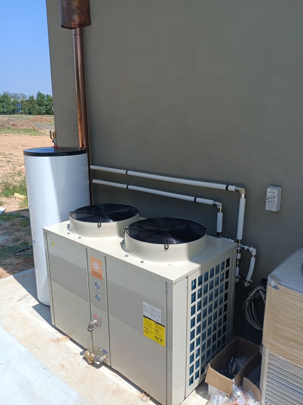 High-capacity twin-fan heat pump with insulated hydronic pipework and buffer storage in Castlereagh.