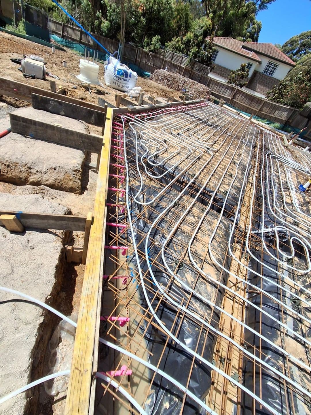 Hydronic underfloor heating pipes installed within a residential concrete slab in Gladesville.