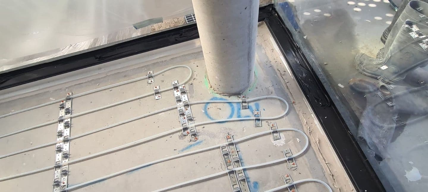 Compact 10mm hydronic pipe loops arranged through a narrow residential floor area.