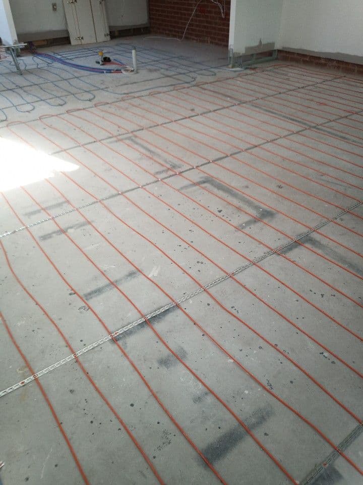 Electric underfloor heating cables laid across a residential room in Lilyfield before screed installation.
